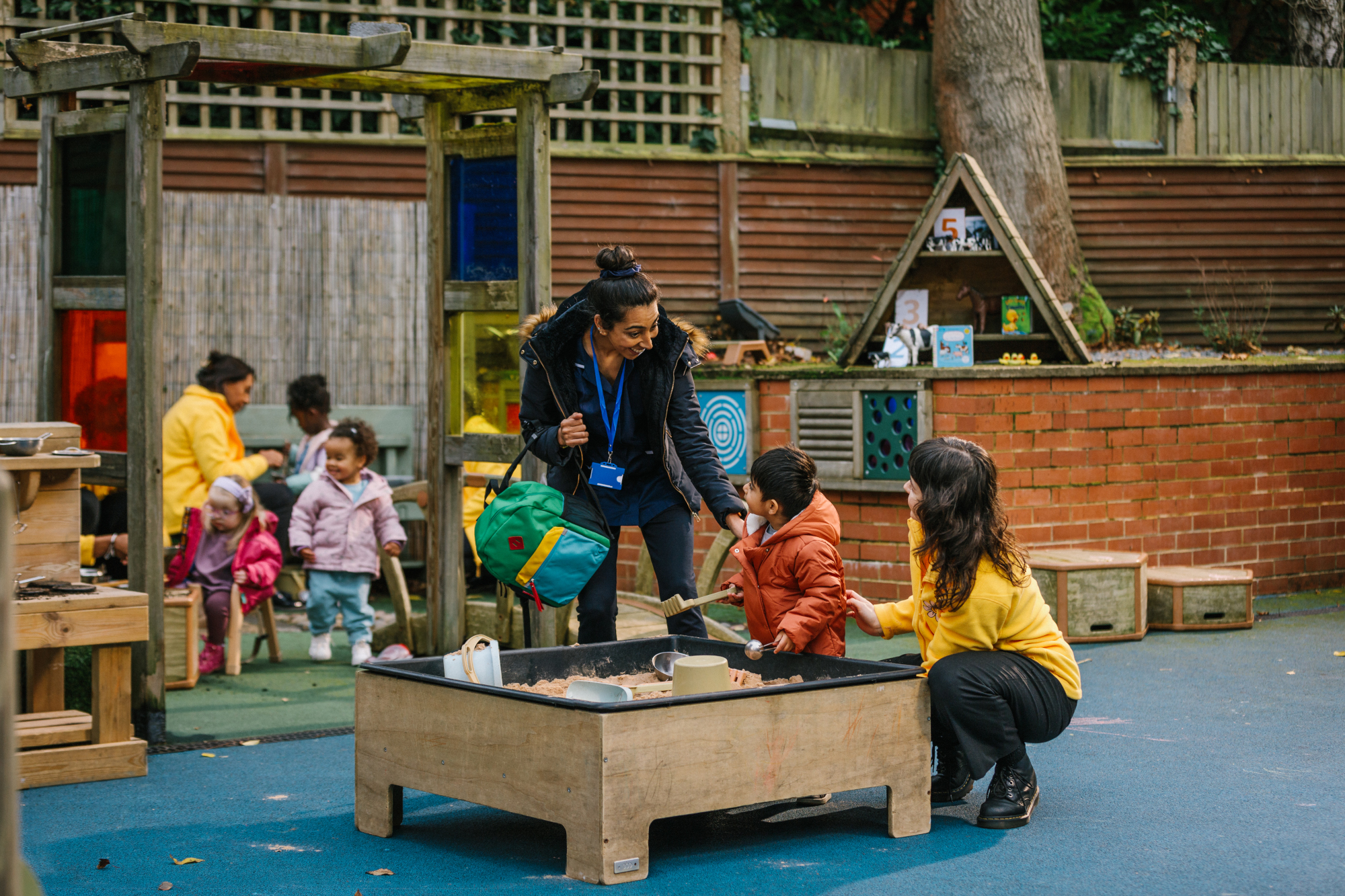 Mum and child at sandpit with child care provider Mum and child at sandpit with child care provider